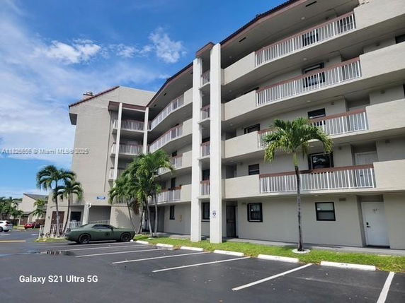 Front view of a multi-story residential building with balconies.