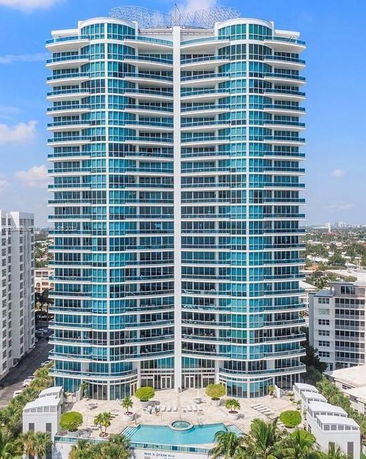 Front view of a modern high-rise building with extensive glass windows.