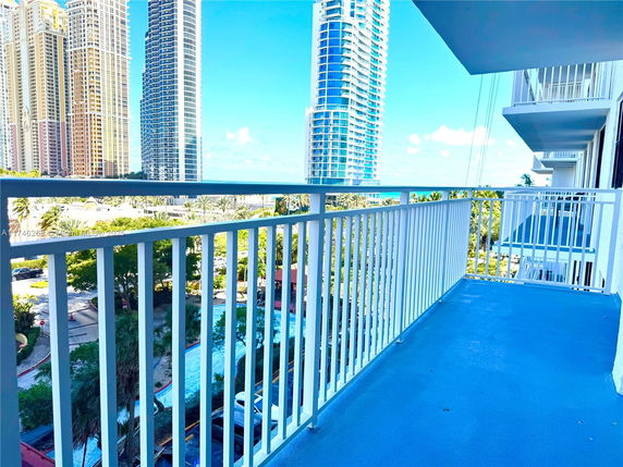 View from a balcony showing high-rise buildings in the distance.