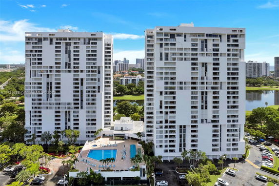 Front view of two high-rise residential buildings with balconies.