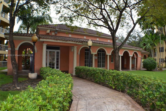 Front view of a building with arched entrances and a tiled roof.