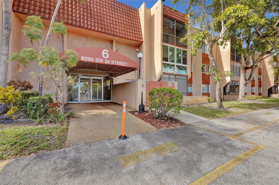 Front view of a building with an entrance canopy marked with the address 8260 SW 24 Street.