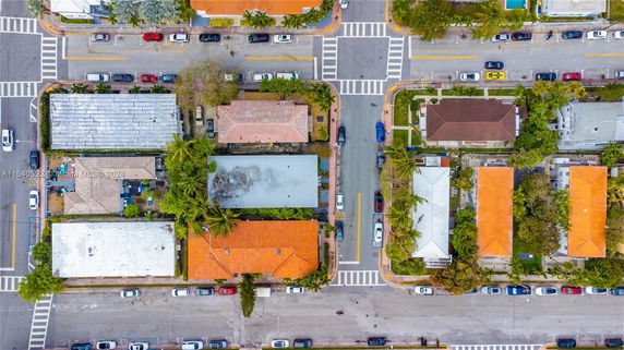 Aerial view of an urban area with several buildings and intersecting streets.