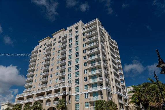 Front view of a high-rise building with multiple balconies.