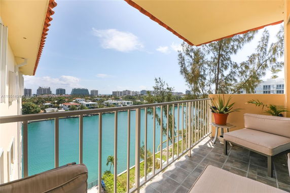 Panoramic view from a building balcony overlooking a waterfront.