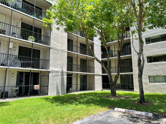 Front view of a multi-story residential building with balconies.