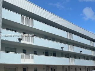 Front view of a multi-story building with balconies.