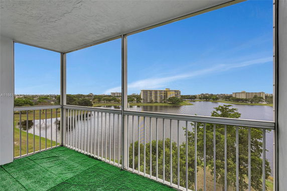 Panoramic view from a balcony overlooking a lake and buildings