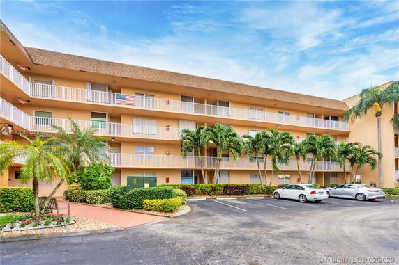 Front view of a multi-story apartment building with balconies.
