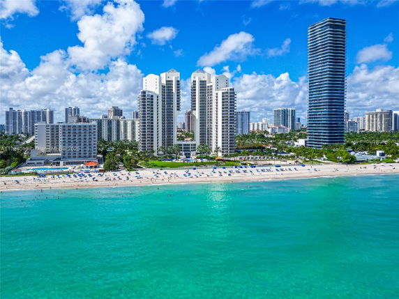 Beachfront view of multiple high-rise buildings.