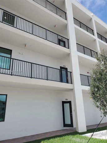 Front view of a multi-story building with balconies.