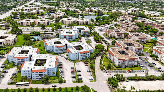 Aerial view of a residential area with multiple multi-story buildings and parking lots.