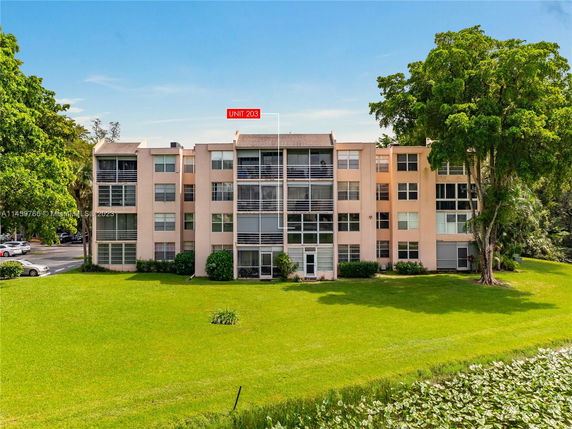 Front view of a multi-story apartment building with balconies.