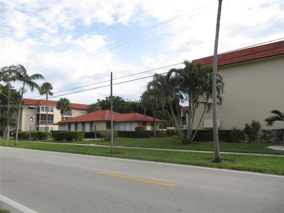 Front view of a residential building with red-tiled roofs.