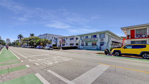 Front view of a row of two-story apartment buildings along a street.