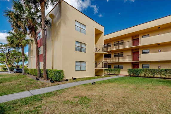 Front view of a multi-story residential building with balconies.