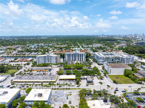 Panoramic view of a cityscape with multiple buildings and green areas.