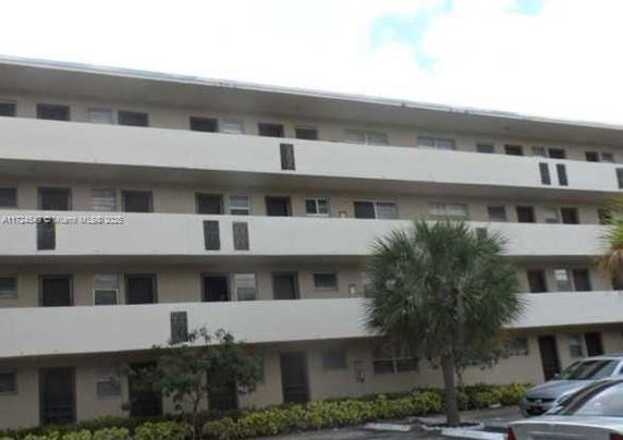 Front view of a multi-story residential building with balconies.