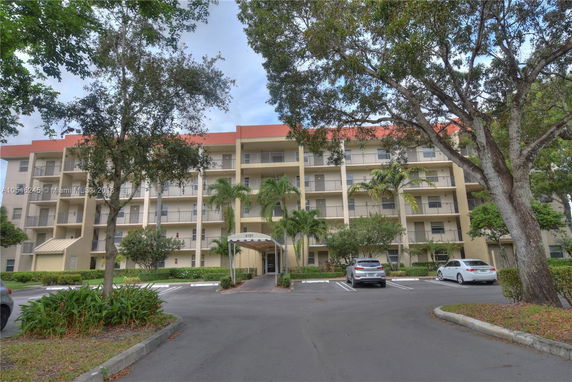 Front view of a multi-story apartment building with balconies.