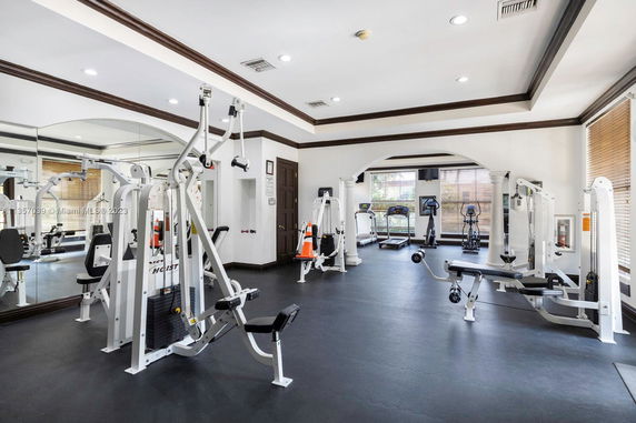 Interior view of a gym with various workout machines and exercise equipment.