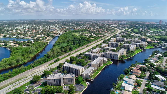 Aerial view of residential area with canals and highways.