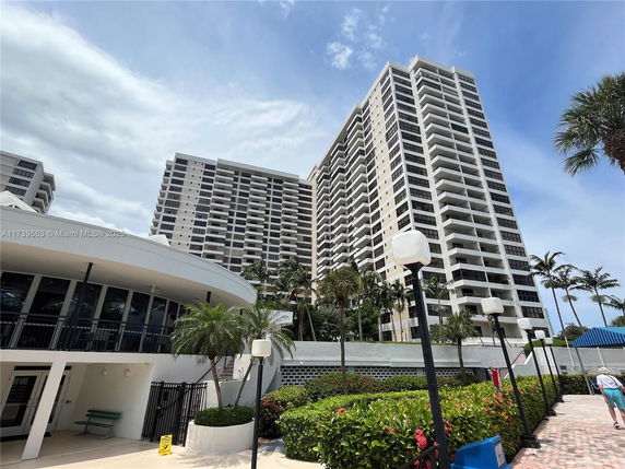 Front view of a high-rise residential building with balconies.