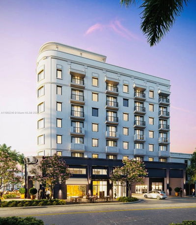 Front view of a multi-story building with balconies and ground-floor commercial spaces.