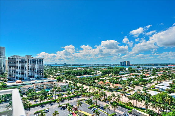 Panoramic view of a cityscape with high-rise buildings, residential areas, and lush greenery.