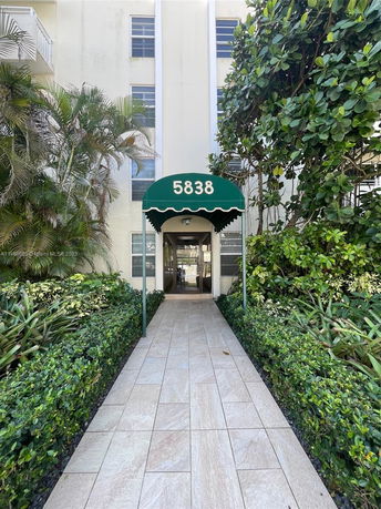 Entrance view of a multi-story building with an awning displaying the number 5838.