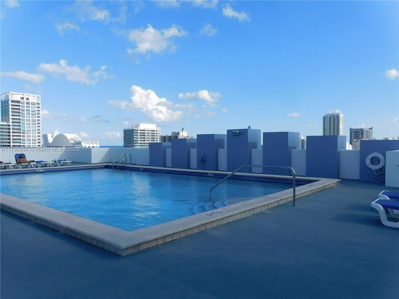 Rooftop swimming pool with surrounding buildings visible.