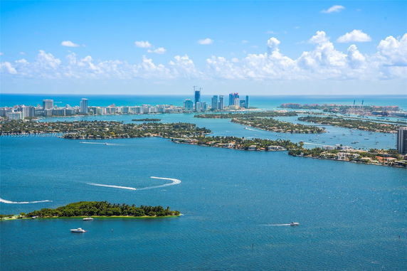 Panoramic view of a coastal city skyline with numerous islands and waterfront buildings.