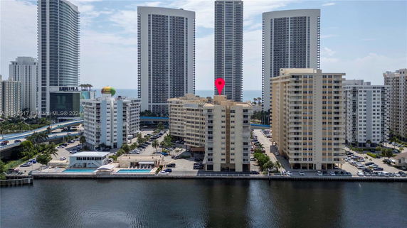 View of tall residential buildings near a waterfront.