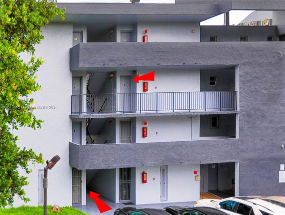 Front view of a three-story apartment building with balconies.