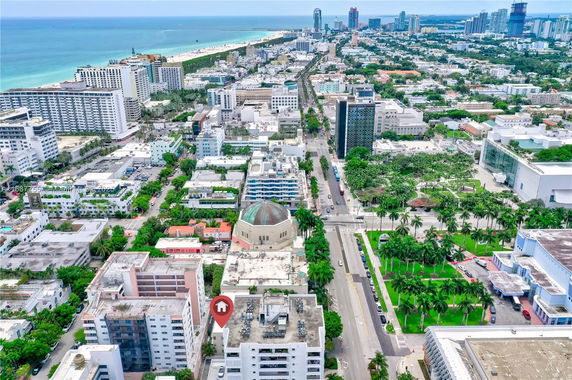 Panoramic view of a coastal city with buildings and beachfront.