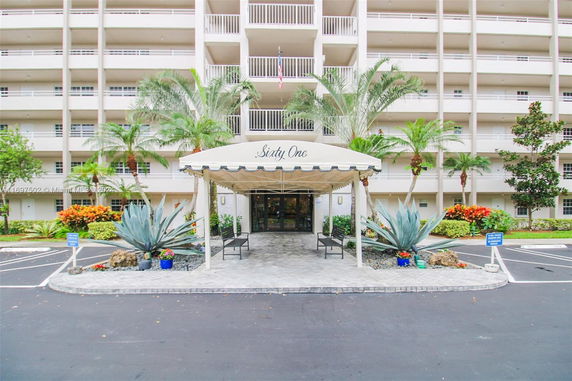 Front view of a multi-story building with a covered entrance.