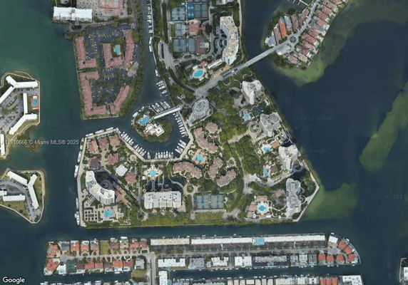 Aerial view of a residential and marina area surrounded by water.