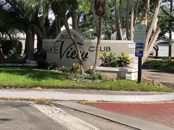 View of the entrance to a property with a sign reading 'Lake View Club'.