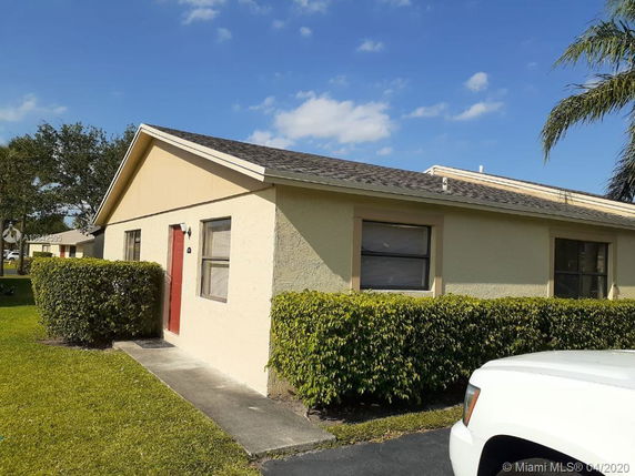 Front view of a single-story house with a red door.