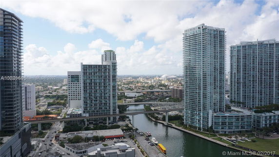 View of surrounding areas featuring tall modern buildings and waterways.