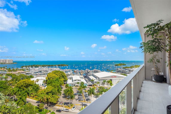 Panoramic view of marina and ocean from a balcony.