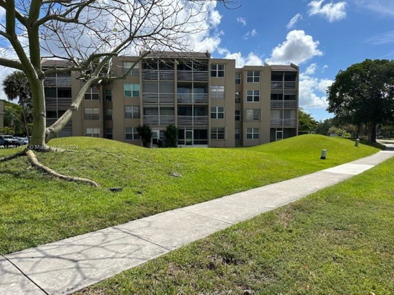 Front view of a multi-story residential building with balconies.