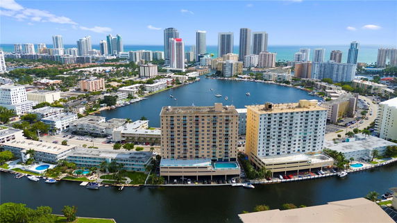 Panoramic view of a cityscape with high-rise buildings overlooking a body of water.