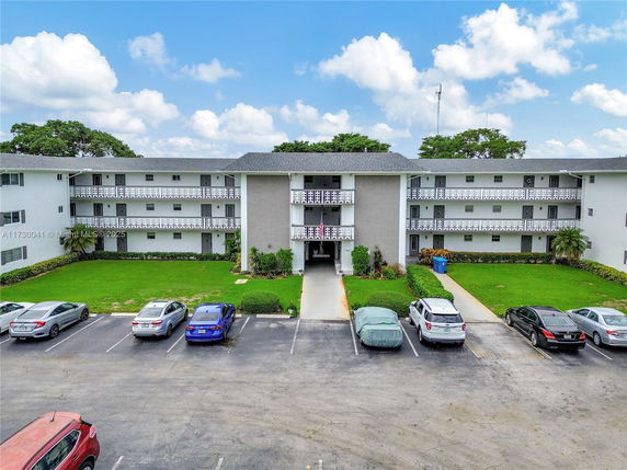 Front view of a multi-story apartment building with balconies.