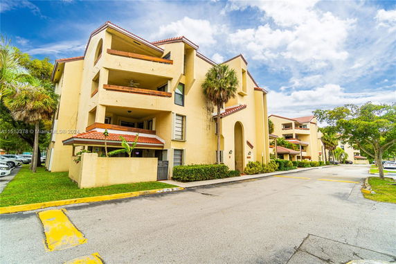 Front view of a multi-story apartment building with balconies.
