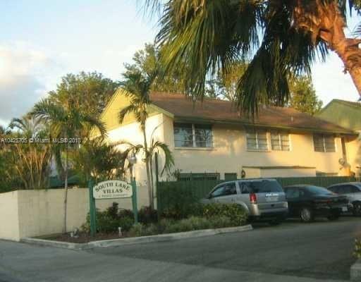 Front view of a two-story house with a sign reading 'South Lake Villas'.