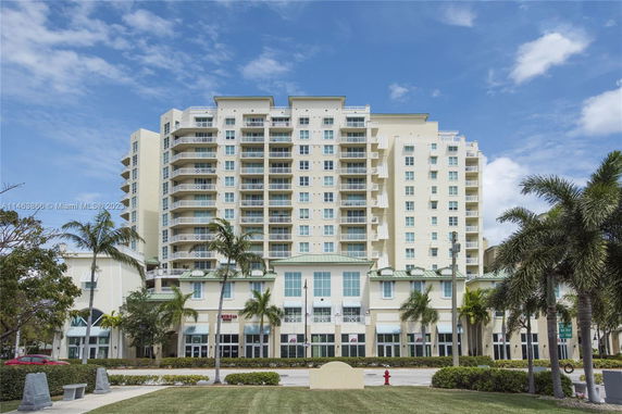 Front view of a multi-story apartment building with balconies.