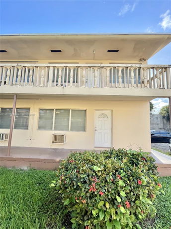 Front view of a two-story building with balcony railings.