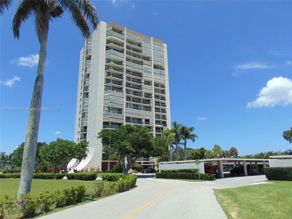 Front view of a multi-story residential building with balconies.