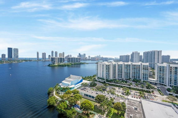 Panoramic view of multiple high-rise buildings along a waterfront.