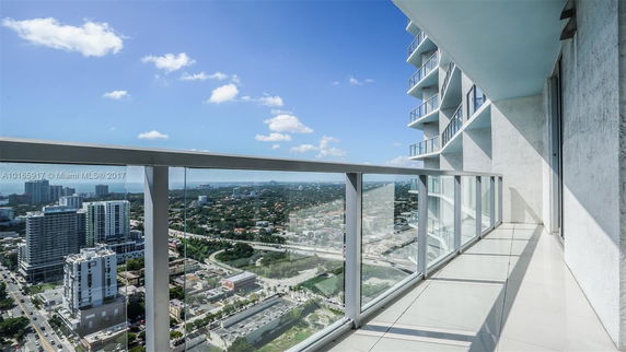 View from a high-rise balcony overlooking the cityscape